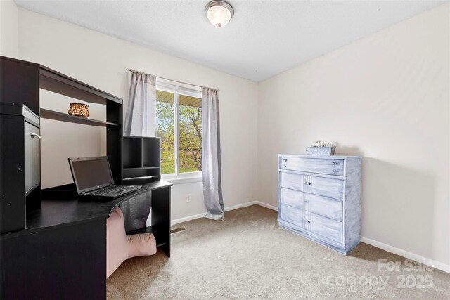 carpeted home office with baseboards
