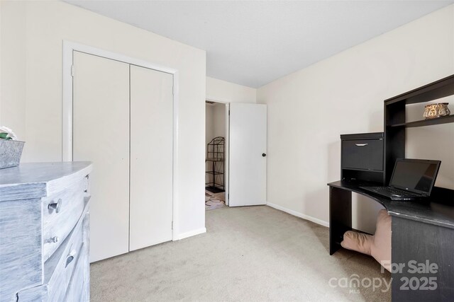 office space featuring light colored carpet and baseboards