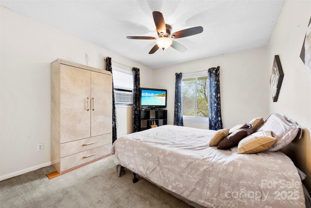 bedroom with a ceiling fan, carpet floors, and baseboards