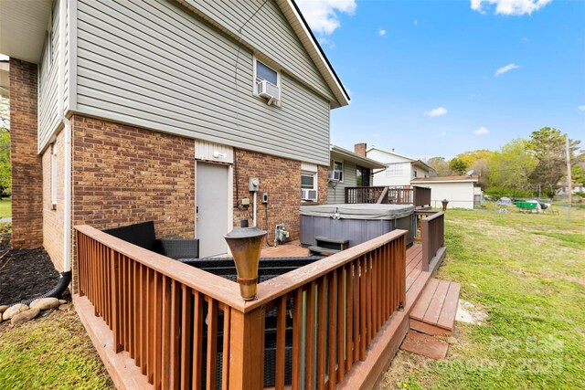 wooden deck with a hot tub, a lawn, and cooling unit