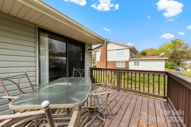 wooden terrace with outdoor dining area
