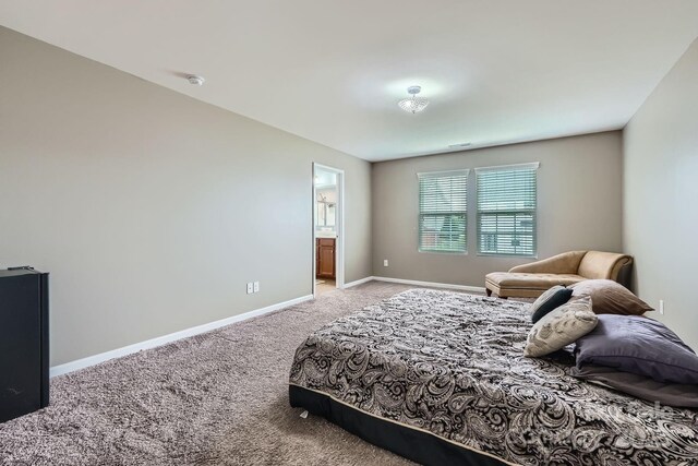 bedroom featuring baseboards and light colored carpet
