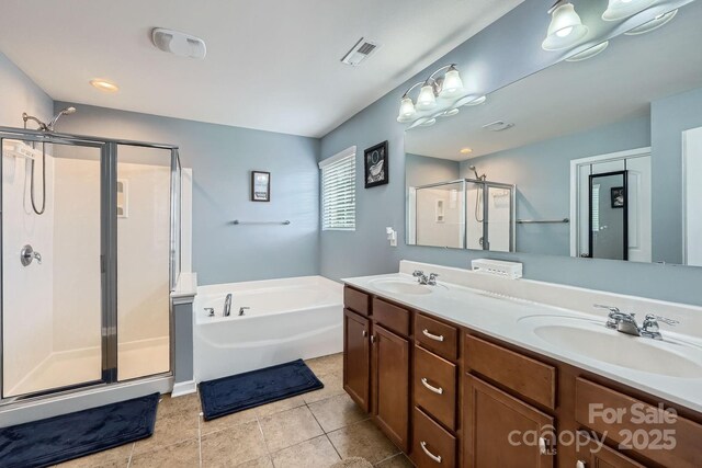 full bath with a sink, double vanity, visible vents, a shower stall, and a garden tub