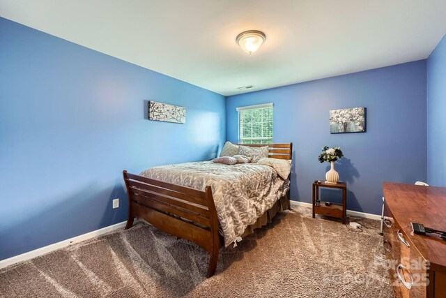 bedroom featuring baseboards and carpet flooring