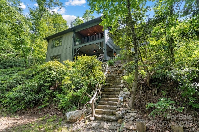 rear view of house with a balcony and stairway