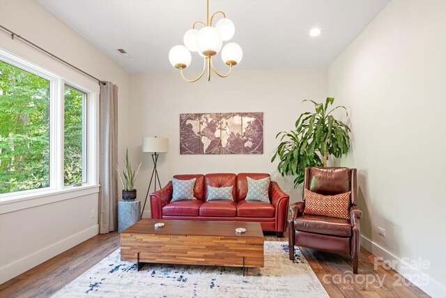 living area featuring wood finished floors, a chandelier, baseboards, and recessed lighting