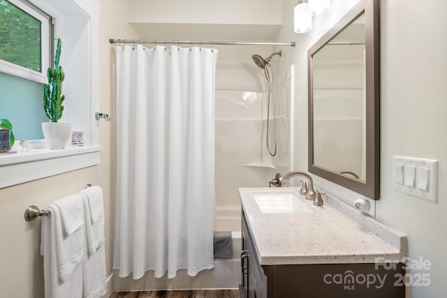 bathroom featuring shower / bath combination with curtain and vanity