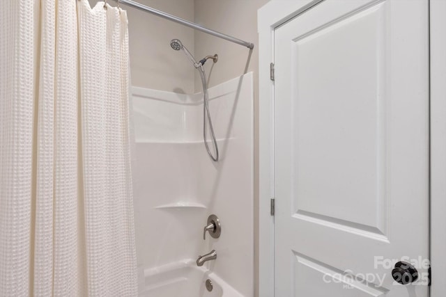 bathroom with shower / bath combo with shower curtain