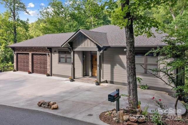 45 Mountain View Rd, Black Mountain, NC 28711 - view of front facade featuring driveway, a garage, a shingled roof, and board and batten siding