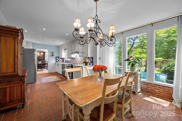 5510 Sardis Rd, Charlotte, NC 28270 - dining space featuring brick flooring, a chandelier, and recessed lighting