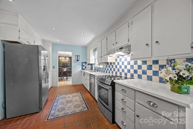 5510 Sardis Rd, Charlotte, NC 28270 - kitchen featuring stainless steel appliances, under cabinet range hood, light countertops, white cabinetry, and recessed lighting