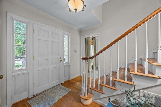5510 Sardis Rd, Charlotte, NC 28270 - foyer with stairway, wood finished floors, crown molding, and baseboards