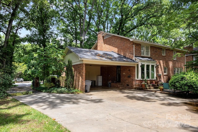 5510 Sardis Rd, Charlotte, NC 28270 - view of front of property with concrete driveway, brick siding, a chimney, and an attached carport