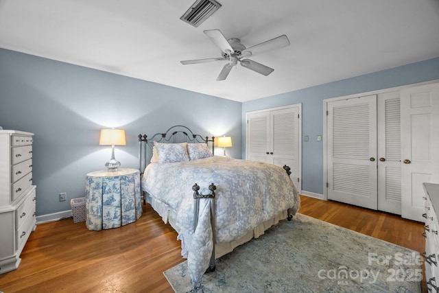 5510 Sardis Rd, Charlotte, NC 28270 - bedroom featuring multiple closets, wood finished floors, baseboards, and a ceiling fan