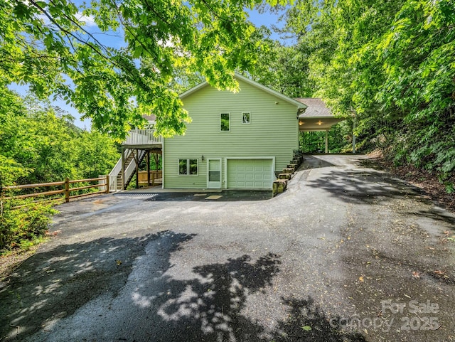 153 Old Lakey Gap Rd, Black Mountain, NC 28711 - view of home's exterior with stairs, asphalt driveway, an attached garage, and fence