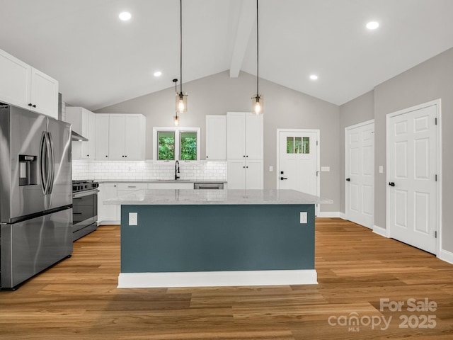 153 Old Lakey Gap Rd, Black Mountain, NC 28711 - kitchen featuring stainless steel appliances, light wood-type flooring, tasteful backsplash, a kitchen island, and beamed ceiling