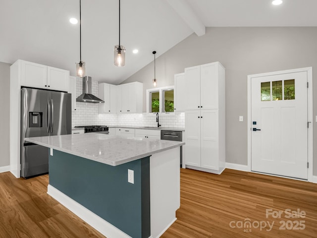 153 Old Lakey Gap Rd, Black Mountain, NC 28711 - kitchen featuring appliances with stainless steel finishes, wall chimney range hood, a sink, light wood-style floors, and white cabinets