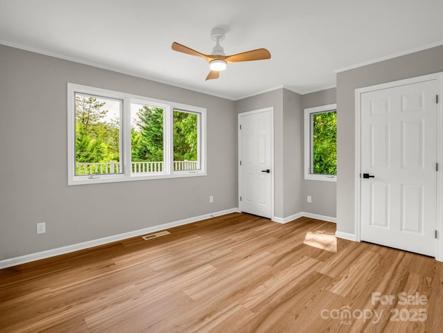153 Old Lakey Gap Rd, Black Mountain, NC 28711 - unfurnished bedroom with ornamental molding, light wood finished floors, baseboards, and a ceiling fan