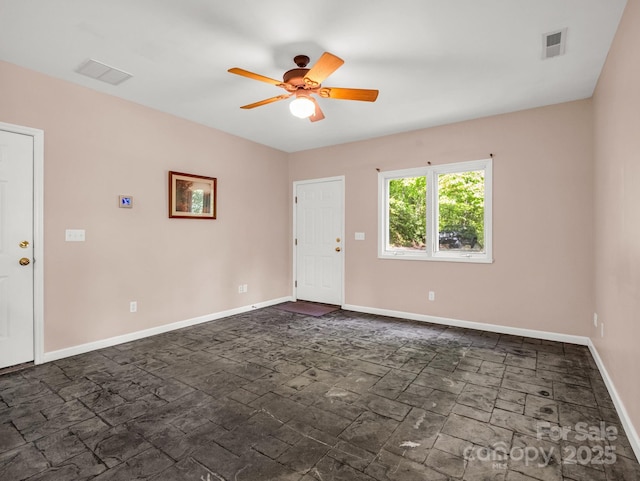 153 Old Lakey Gap Rd, Black Mountain, NC 28711 - spare room with ceiling fan, baseboards, and dark stone finish floors