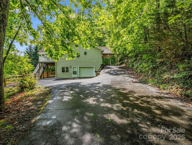 153 Old Lakey Gap Rd, Black Mountain, NC 28711 - rear view of house with asphalt driveway, stairway, and an attached garage