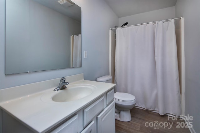 full bath with vanity, curtained shower, toilet, visible vents, and wood finished floors