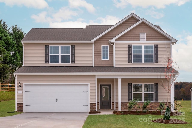 craftsman inspired home featuring fence, stone siding, driveway, a front lawn, and a garage