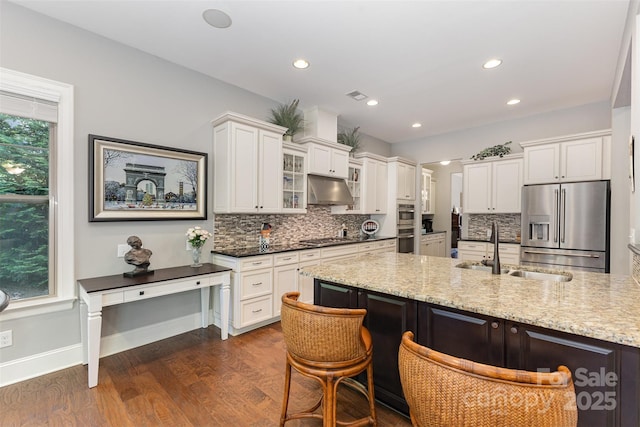 5706 Sardis Hall Ct, Charlotte, NC 28270 - kitchen featuring backsplash, dark wood finished floors, a sink, under cabinet range hood, and stainless steel appliances