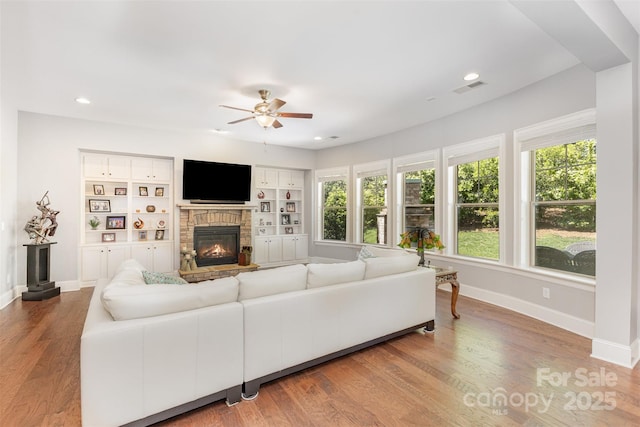5706 Sardis Hall Ct, Charlotte, NC 28270 - living area featuring a glass covered fireplace, baseboards, ceiling fan, and visible vents