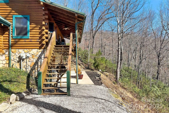 2245 Mckenzie Way N Unit 754, Old Fort, NC 28762 - view of side of home featuring log exterior, stone siding, stairs, and a view of trees
