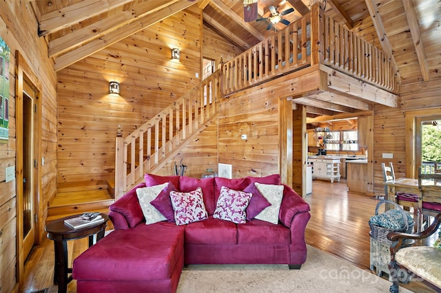 2245 Mckenzie Way N Unit 754, Old Fort, NC 28762 - living room with a wooden ceiling with exposed beams, wood walls, stairway, hardwood / wood-style floors, and high vaulted ceiling