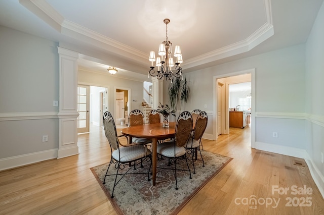 4599 Rustling Woods Dr, Denver, NC 28037 - dining space with a raised ceiling, ornamental molding, a chandelier, stairs, and light wood-style flooring