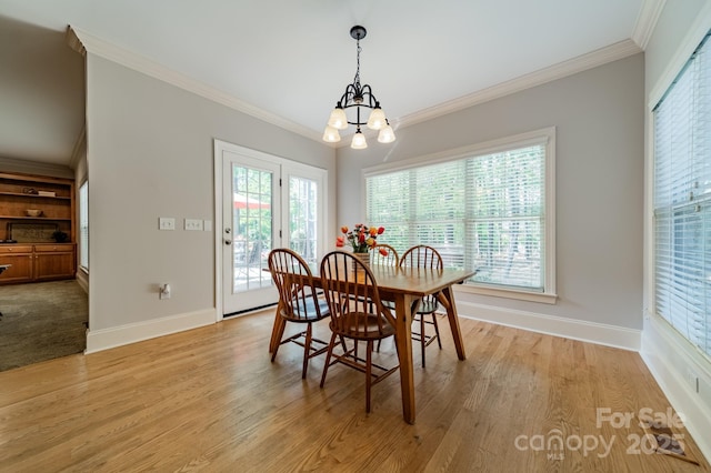 4599 Rustling Woods Dr, Denver, NC 28037 - dining room featuring a chandelier, crown molding, baseboards, and light wood-style flooring