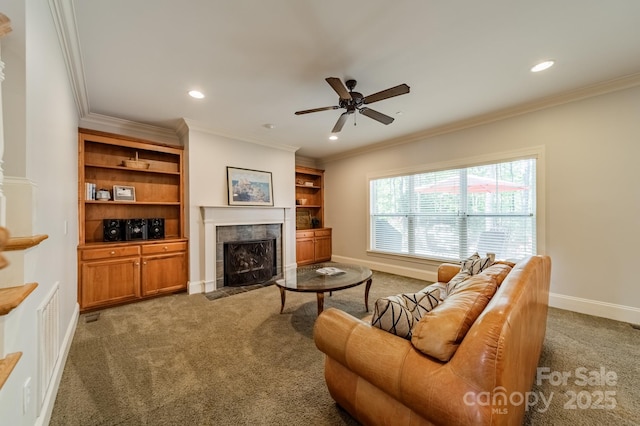 4599 Rustling Woods Dr, Denver, NC 28037 - carpeted living area with a tiled fireplace, crown molding, baseboards, recessed lighting, and a ceiling fan