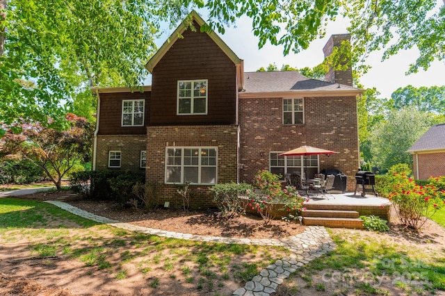 4599 Rustling Woods Dr, Denver, NC 28037 - rear view of property featuring a chimney, a patio area, and brick siding