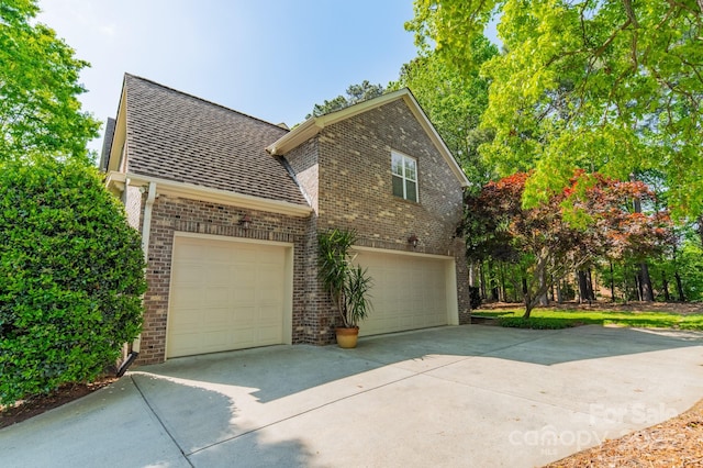 4599 Rustling Woods Dr, Denver, NC 28037 - view of side of home with brick siding, concrete driveway, and a shingled roof