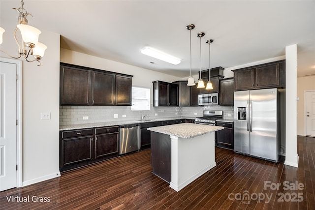 1929 Shorthorn St, Charlotte, NC 28213 - kitchen with dark brown cabinetry, dark wood-style flooring, a sink, and stainless steel appliances