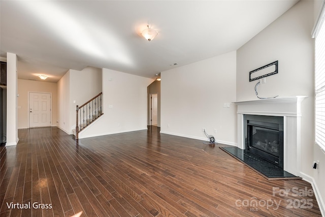 1929 Shorthorn St, Charlotte, NC 28213 - unfurnished living room with baseboards, stairway, a fireplace, and dark wood finished floors
