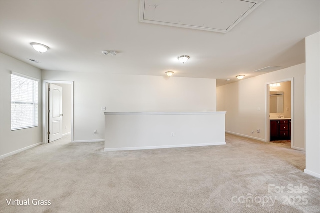 1929 Shorthorn St, Charlotte, NC 28213 - unfurnished room featuring visible vents, baseboards, attic access, a sink, and light colored carpet