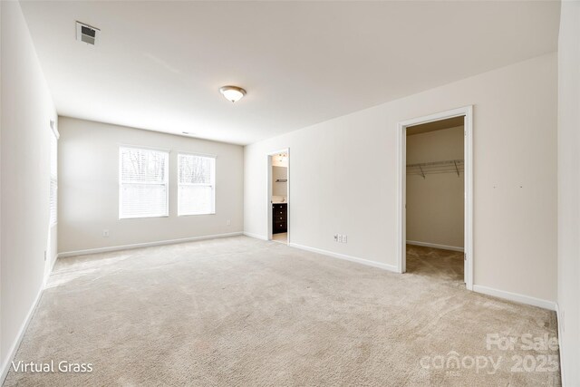 1929 Shorthorn St, Charlotte, NC 28213 - unfurnished bedroom featuring a spacious closet, carpet flooring, baseboards, visible vents, and a closet