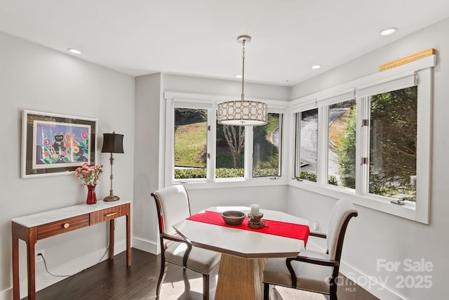 dining space with baseboards, dark wood finished floors, recessed lighting, and plenty of natural light
