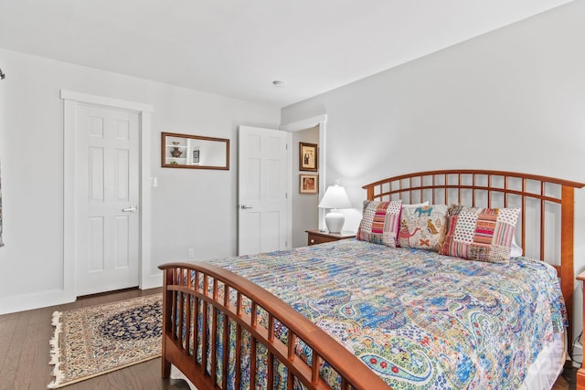 bedroom with baseboards and wood finished floors