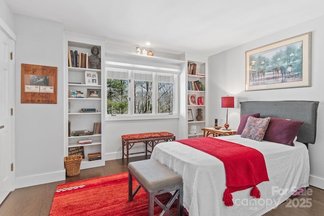 bedroom featuring baseboards and wood finished floors