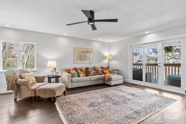 living room with ceiling fan, hardwood / wood-style flooring, and a healthy amount of sunlight