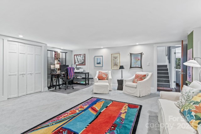 carpeted living room featuring stairs and recessed lighting