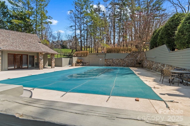 view of pool with fence and a patio