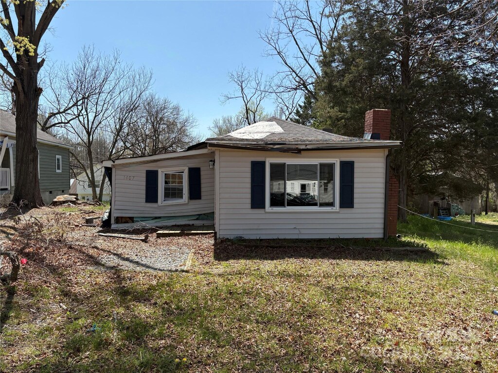 1407 Birch St, Kannapolis, NC 28081 - view of home's exterior featuring a chimney and a yard