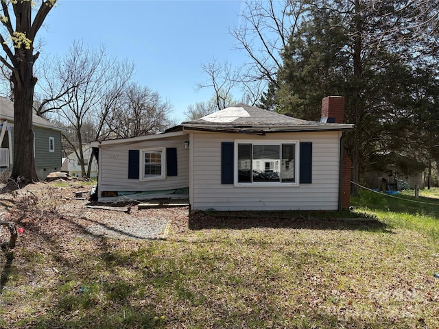 1407 Birch St, Kannapolis, NC 28081 - view of home's exterior featuring a chimney and a yard