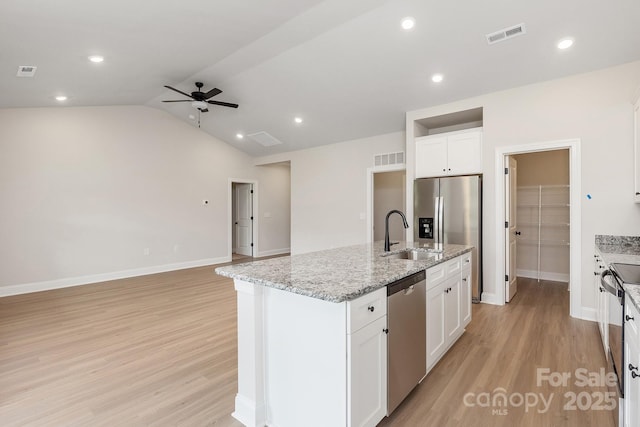 7015 Jerimoth Dr, Charlotte, NC 28215 - kitchen with stainless steel appliances, a sink, ceiling fan, light wood finished floors, and vaulted ceiling