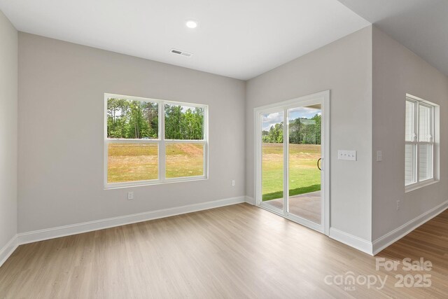 7015 Jerimoth Dr, Charlotte, NC 28215 - empty room featuring wood finished floors, plenty of natural light, baseboards, and recessed lighting