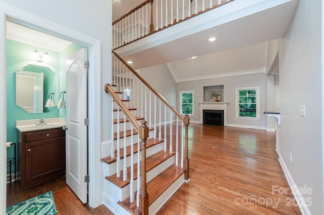 6414 Winding Creek Ln, Denver, NC 28037 - staircase featuring wood finished floors, a fireplace, ornamental molding, and baseboards